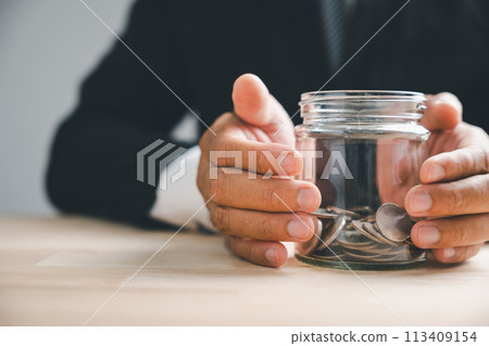 Money minded businessman aims for real estate income through investment growth. Planning future wealth with property, house value, and financial success. Bank on currency, economy, insurance. 113409154