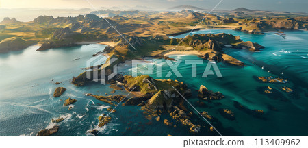 An aerial shot captures the stunning coastal landscape bathed in the warm light of the sunset, highlighting the contrast between land and sea. An aerial shot captures the stunning coastal landscape bathed in the warm light of the sunset, highlighting the contrast between land and sea. 113409962
