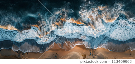The stunning interplay of light and shadow is captured in this aerial photo of gentle waves washing onto a sunlit sandy beach. The stunning interplay of light and shadow is captured in this aerial photo of gentle waves washing onto a sunlit sandy beach. 113409963