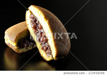 Cut dorayaki photographed against a black background Cut dorayaki photographed against a black background 113410548