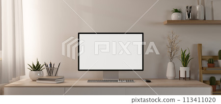 A contemporary minimalist home office features a computer mockup and decor on a minimal wood table. A contemporary minimalist home office features a computer mockup and decor on a minimal wood table. 113411020