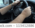 Hands on a steering wheel 113412886