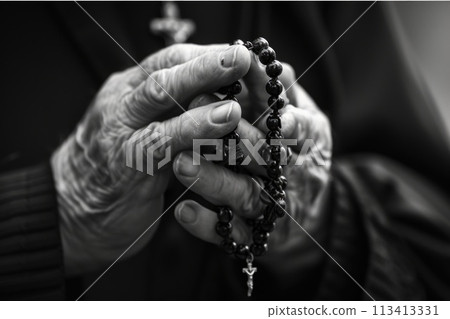 Soulful prayer: a man in quiet devotion, hands clasped around a rosary cross, seeking solace and spiritual connection, capturing the essence of serene contemplation, faith, and religious devotion. 113413331