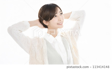 A young Asian woman with short hair putting her hands behind her head A young Asian woman with short hair putting her hands behind her head 113414148