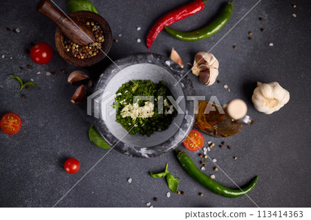 stone mortar with green sauce chopped ingredients 113414363