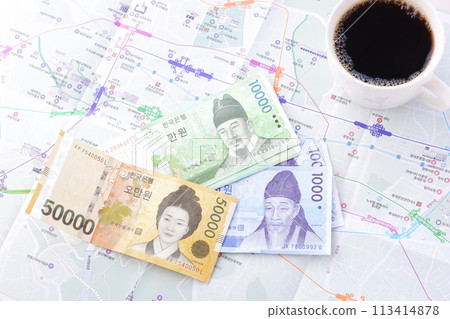 Korean currency, won (KRW) (banknotes) and a coffee cup filled with coffee Korean currency, won (KRW) (banknotes) and a coffee cup filled with coffee 113414878