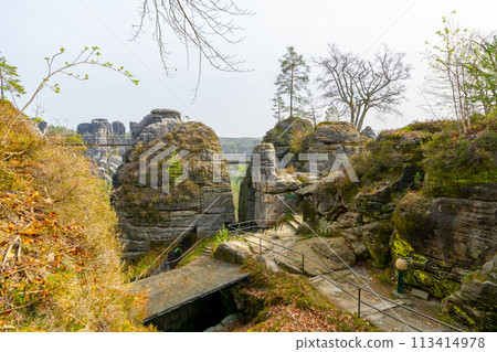 Seasonal colors frame the rocky remnants of Neurathen Castle in Bastai Sandstone Rocks of Saxon Switzerland National Park. Germany 113414978