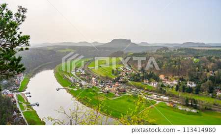 Overlooking the gentle curve of the Elbe River, surrounded by the lush greenery of Saxon Switzerland National Park. Germany Overlooking the gentle curve of the Elbe River, surrounded by the lush greenery of Saxon Switzerland National Park. Germany 113414980