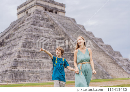 Beautiful tourist woman and her son observing the old pyramid and temple of the castle of the Mayan architecture known as Chichen Itza these are the ruins of this ancient pre-columbian civilization Beautiful tourist woman and her son observing the old pyramid and temple of the castle of the Mayan architecture known as Chichen Itza these are the ruins of this ancient pre-columbian civilization 113415480