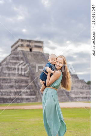 Beautiful tourist woman and her son baby observing the old pyramid and temple of the castle of the Mayan architecture known as Chichen Itza these are the ruins of this ancient pre-columbian 113415544