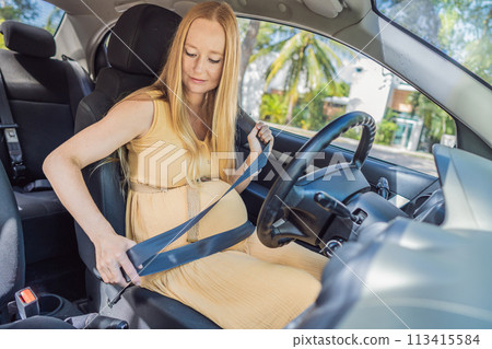 Pregnant woman driving with safety belt on in the car. Confident and capable, a pregnant woman takes the wheel, driving with care and determination as she navigates the journey of motherhood 113415584