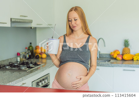 Happy pregnant young woman eating ice cream Happy pregnant young woman eating ice cream 113415604