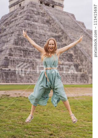 Beautiful tourist woman observing the old pyramid and temple of the castle of the Mayan architecture known as Chichen Itza these are the ruins of this ancient pre-columbian civilization and part of 113415697