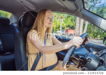 Pregnant woman driving with safety belt on in the car. Confident and capable, a pregnant woman takes the wheel, driving with care and determination as she navigates the journey of motherhood 113415726