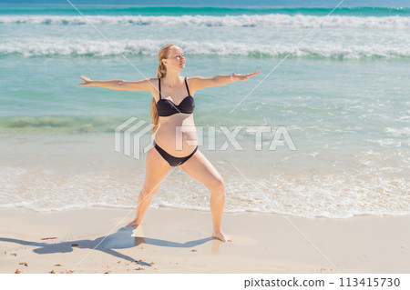 Harmonizing mind and body, a pregnant woman gracefully practices yoga on the beach, embracing the serenity of the seaside for a tranquil and mindful pregnancy experience 113415730
