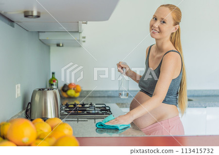 Efficient and dedicated, a pregnant woman tackles kitchen chores, ensuring a clean and organized space, exemplifying resilience and care during her pregnancy 113415732