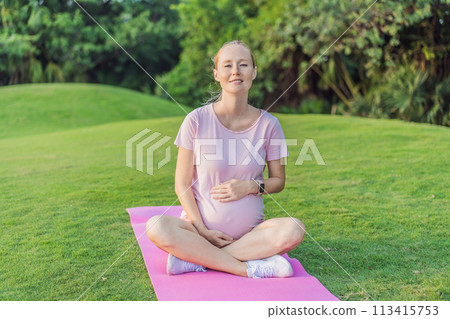 Energetic pregnant woman takes her workout outdoors, using an exercise mat for a refreshing and health-conscious outdoor exercise session 113415753