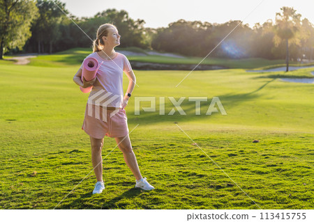 Energetic pregnant woman takes her workout outdoors, using an exercise mat for a refreshing and health-conscious outdoor exercise session 113415755