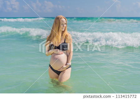 In the idyllic embrace of the Caribbean Sea, a pregnant woman finds bliss, savoring the warmth and serenity of the tropical waters during her pregnancy In the idyllic embrace of the Caribbean Sea, a pregnant woman finds bliss, savoring the warmth and serenity of the tropical waters during her pregnancy 113415772