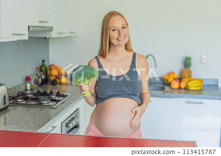 Embracing a nutrient-rich choice, a pregnant woman eagerly prepares to enjoy a wholesome serving of broccoli, prioritizing healthy and nourishing options during her pregnancy 113415787