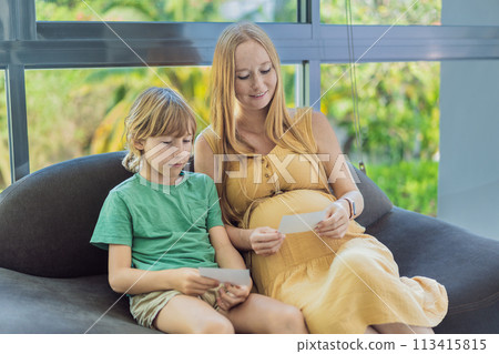 Expectant mother tenderly shares the joy of her unborn baby with her son, showing him heartwarming ultrasound photos of his soon-to-arrive little brother Expectant mother tenderly shares the joy of her unborn baby with her son, showing him heartwarming ultrasound photos of his soon-to-arrive little brother 113415815