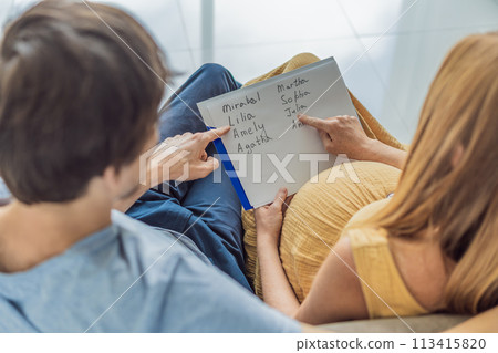 Expectant couple joyfully selects a name for their unborn daughter, savoring the special moment of choosing a meaningful identity for their growing family 113415820