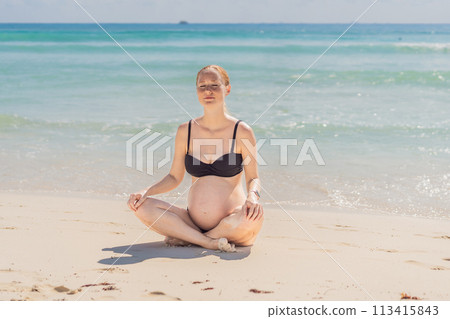 Harmonizing mind and body, a pregnant woman gracefully practices yoga on the beach, embracing the serenity of the seaside for a tranquil and mindful pregnancy experience 113415843