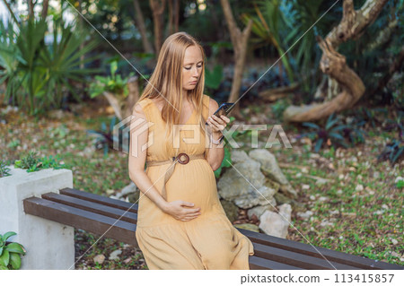 pregnant woman enjoys the tranquility of the park, captivated by her phone, blending the beauty of nature with the modern connection during her pregnancy pregnant woman enjoys the tranquility of the park, captivated by her phone, blending the beauty of nature with the modern connection during her pregnancy 113415857