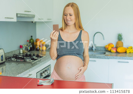 Contemplating the sweet dilemma, a pregnant woman ponders the decision to indulge in chocolate during pregnancy, weighing the delightful treat's potential impact on her maternal journey 113415878