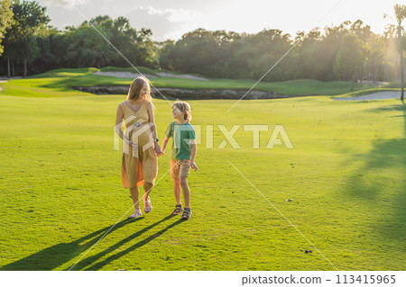 Heartwarming outdoor bonding as a pregnant mom and her son enjoy quality time together, savoring the beauty of nature and creating cherished moments 113415965