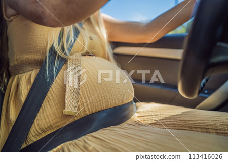 Pregnant woman driving with safety belt on in the car. Confident and capable, a pregnant woman takes the wheel, driving with care and determination as she navigates the journey of motherhood Pregnant woman driving with safety belt on in the car. Confident and capable, a pregnant woman takes the wheel, driving with care and determination as she navigates the journey of motherhood 113416026