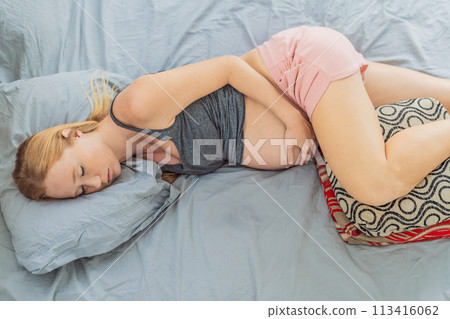Sleep-deprived pregnant woman struggles with insomnia, navigating the challenges of restlessness during pregnancy Sleep-deprived pregnant woman struggles with insomnia, navigating the challenges of restlessness during pregnancy 113416062