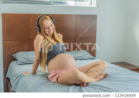 Expectant mom finds joy in her pregnancy, listening to soothing music for a serene and harmonious connection with her unborn baby 113416084