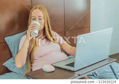 Resourceful pregnant woman works from the cozy confines of her bed at home, combining productivity with a comforting coffee break during the remote work session Resourceful pregnant woman works from the cozy confines of her bed at home, combining productivity with a comforting coffee break during the remote work session 113416124
