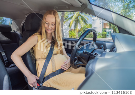 Pregnant woman driving with safety belt on in the car. Confident and capable, a pregnant woman takes the wheel, driving with care and determination as she navigates the journey of motherhood Pregnant woman driving with safety belt on in the car. Confident and capable, a pregnant woman takes the wheel, driving with care and determination as she navigates the journey of motherhood 113416168