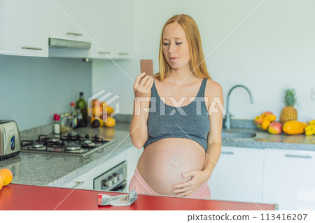 Contemplating the sweet dilemma, a pregnant woman ponders the decision to indulge in chocolate during pregnancy, weighing the delightful treat's potential impact on her maternal journey 113416207