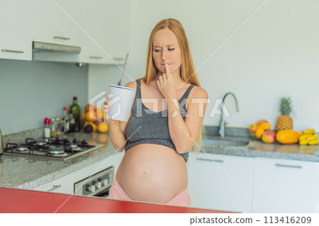 Happy pregnant young woman eating ice cream Happy pregnant young woman eating ice cream 113416209