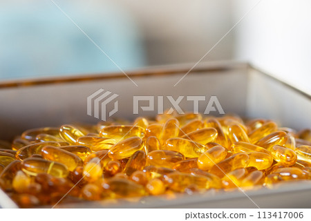 Capsules Omega 3 blurred background. Close up, high resolution product. Health care concept Capsules Omega 3 blurred background. Close up, high resolution product. Health care concept 113417006