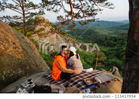 happy couple having date at the cliff on sunset 113417054