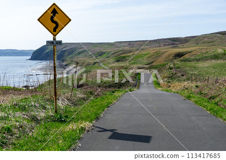 A sign on a remote island warning of a right-turn A sign on a remote island warning of a right-turn 113417685