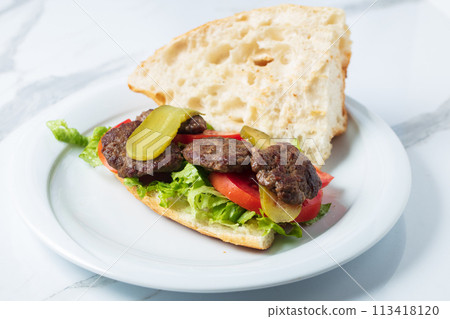 Traditional Turkish meatballs served with French fries tomatoes . High quality photo Traditional Turkish meatballs served with French fries tomatoes . High quality photo 113418120