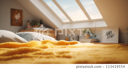 Bed with yellow blanket in attic bedroom. 113419554