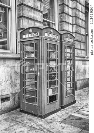 Traditional british red phone booth in London, UK 113419864