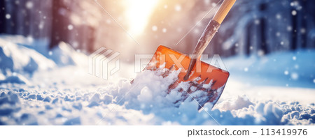 A shovel for clearing snow standing in a snowdrift. A shovel for clearing snow standing in a snowdrift. 113419976
