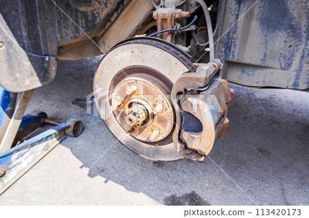Worn used car brake disk close up. Changing wheels and brakes. Worn used car brake disk close up. Changing wheels and brakes. 113420173