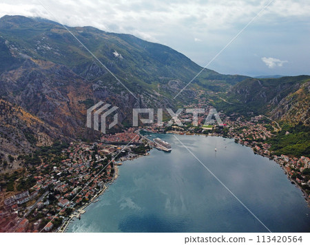 Aerial drone high view of Kotor bay, Boka Kotorska and coastal town Kotor, Cattaro, in Montenegro. Location place famous resort Montenegro. Adriatic fjord surrounded by rugged mountains Aerial drone high view of Kotor bay, Boka Kotorska and coastal town Kotor, Cattaro, in Montenegro. Location place famous resort Montenegro. Adriatic fjord surrounded by rugged mountains 113420564