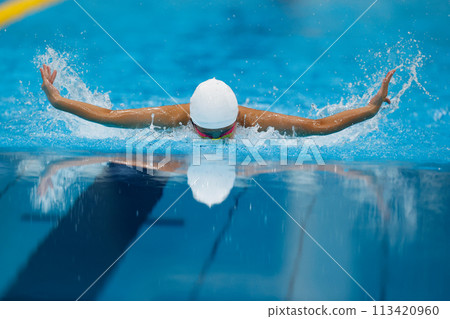 Swimming competition, butterfly stroke athlete 113420960
