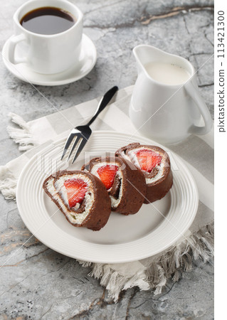 Strawberry chocolate Swiss roll cheesecake served with coffee close-up. Vertical 113421300