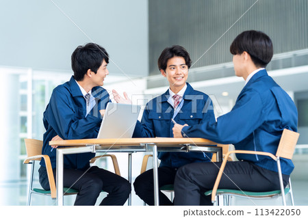 一位年輕男工程師穿著工作服開會 113422050