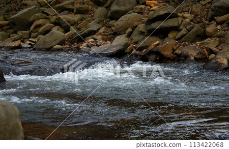 Rivulet on a small mountain river running between rocky shores Rivulet on a small mountain river running between rocky shores 113422068